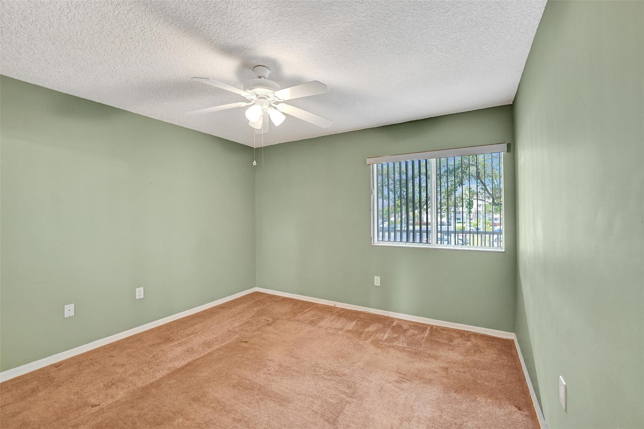 9563 Weldon Circle, Unit D212 Tamarac, FL 33321 - Photo 39 of 69 an empty room with a window and ceiling fan