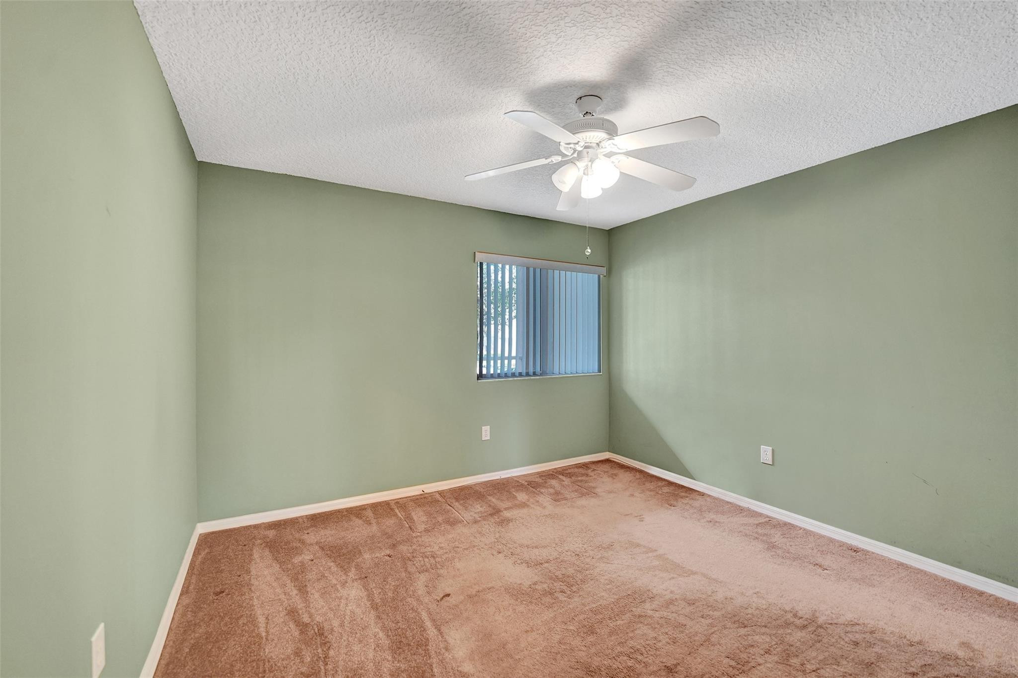 9563 Weldon Circle, Unit D212 Tamarac, FL 33321 - Photo 41 of 69 an empty room with a window and a fan
