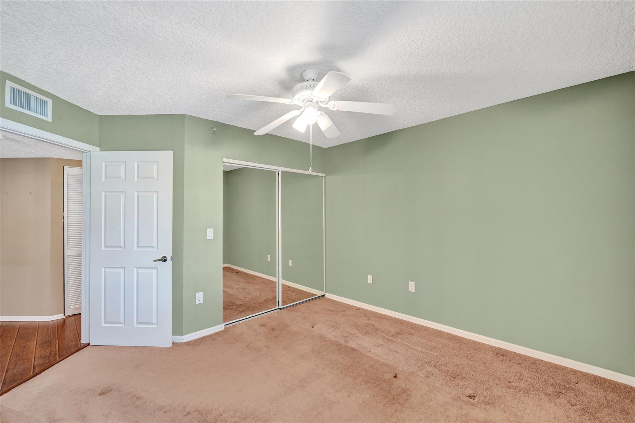 9563 Weldon Circle, Unit D212 Tamarac, FL 33321 - Photo 42 of 69 an empty room with closet and a ceiling fan