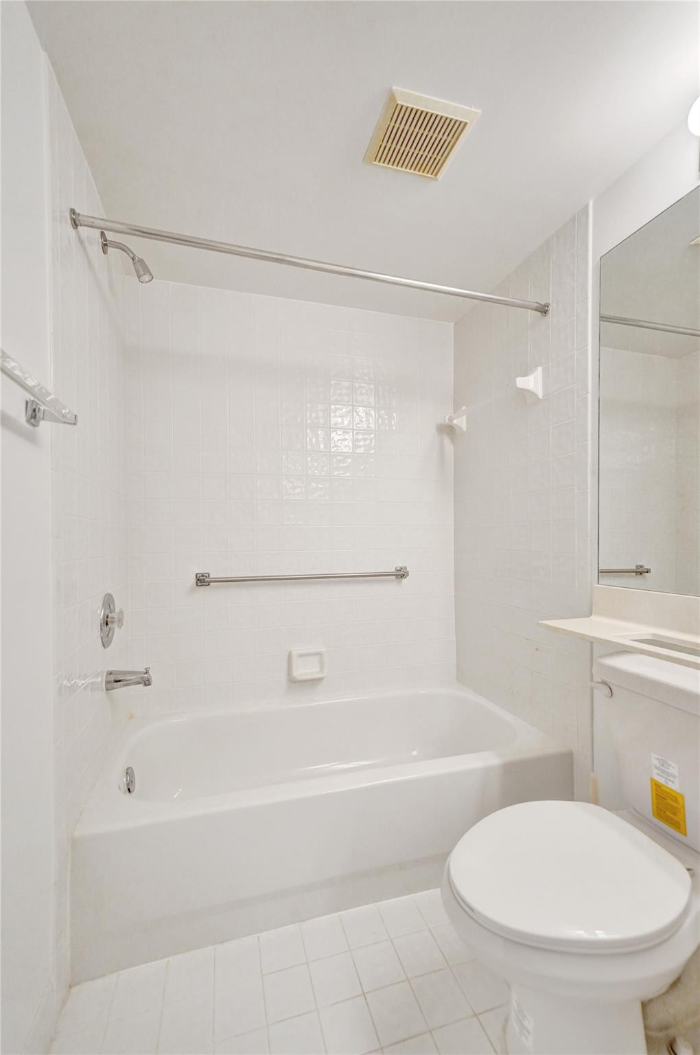 9563 Weldon Circle, Unit D212 Tamarac, FL 33321 - Photo 46 of 69 a bathroom with a tub shower sink and toilet