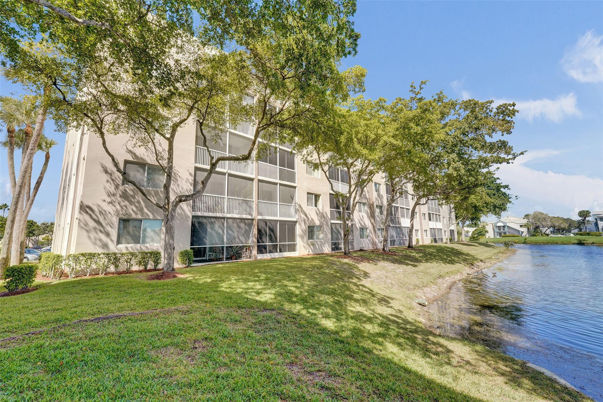 9563 Weldon Circle, Unit D212 Tamarac, FL 33321 - Photo 55 of 69 a view of a building with a yard