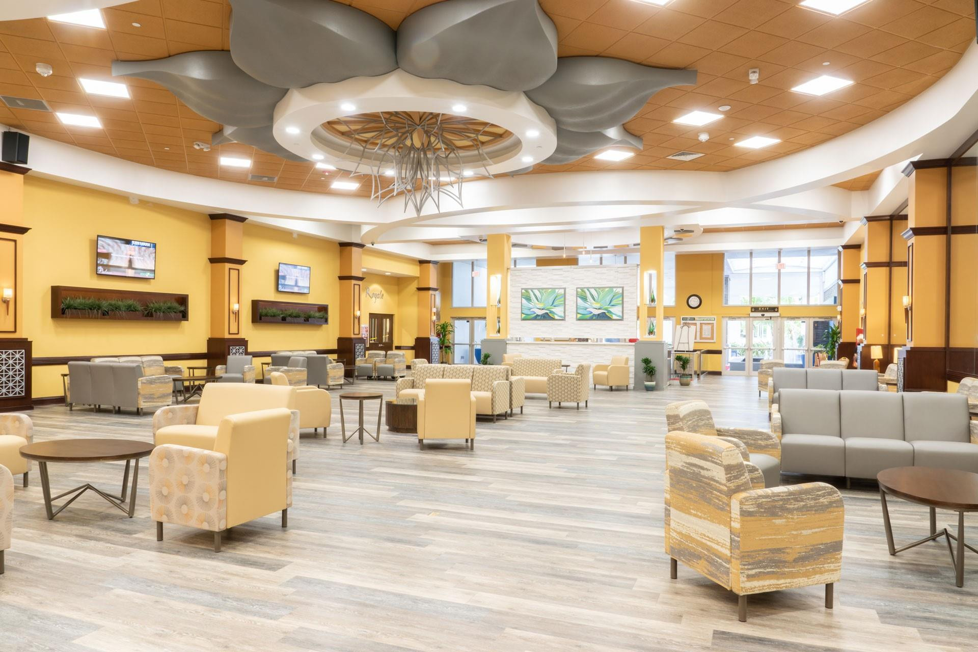 9563 Weldon Circle, Unit D212 Tamarac, FL 33321 - Photo 68 of 69 a living room with lots of furniture and a chandelier