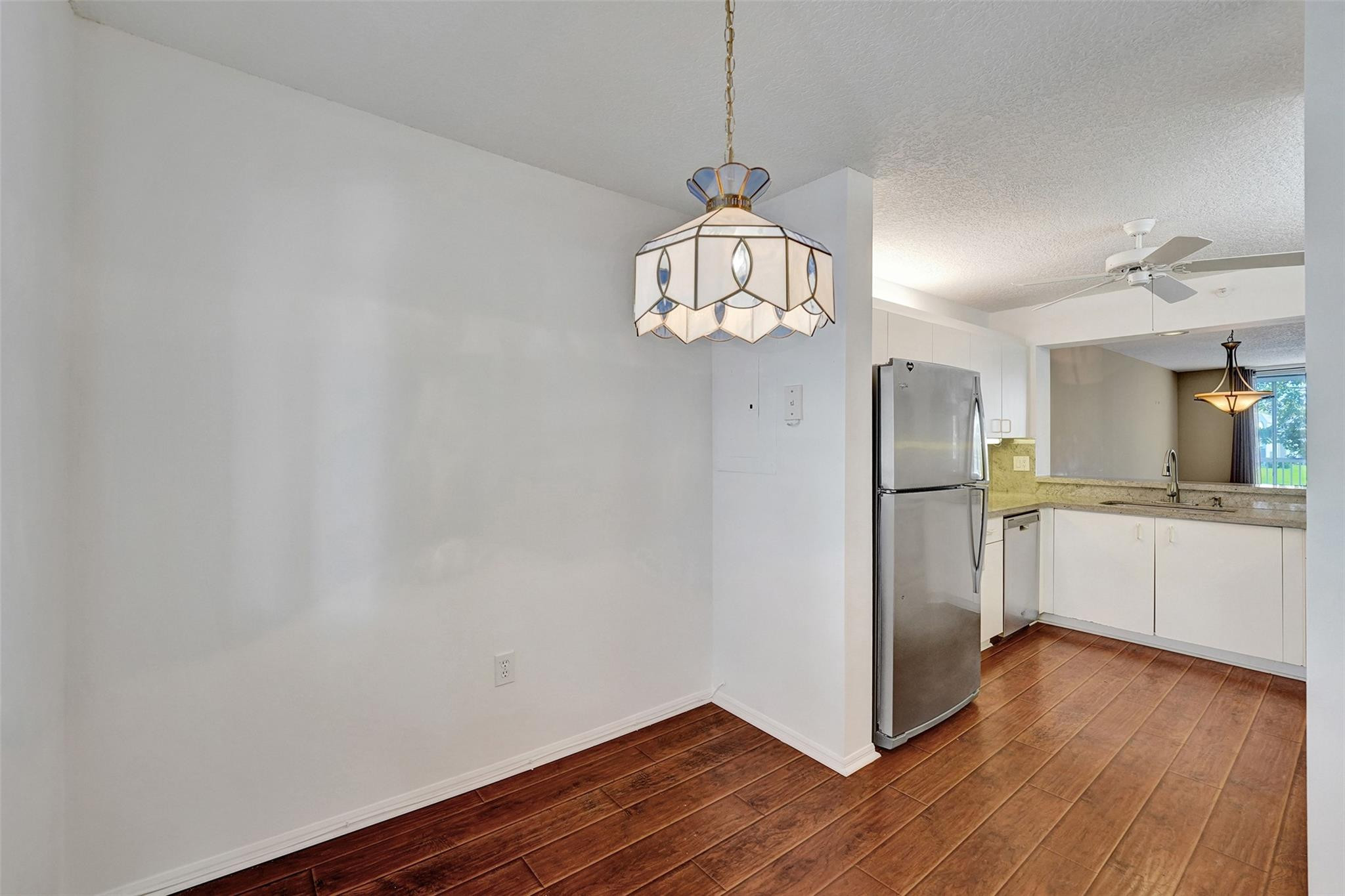 9563 Weldon Circle, Unit D212 Tamarac, FL 33321 - Photo 8 of 69 a view of a kitchen with stainless steel appliances granite countertop a refrigerator and a wooden floor