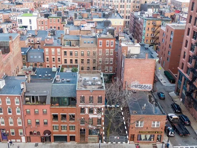 an aerial view of a building with a street