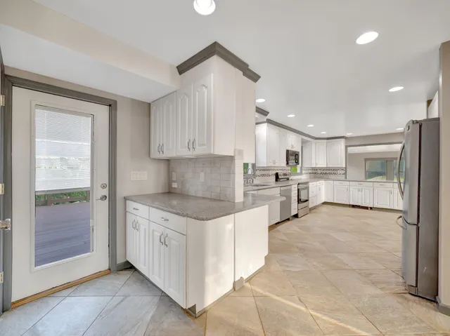 a view of empty room with cabinet and wooden floor