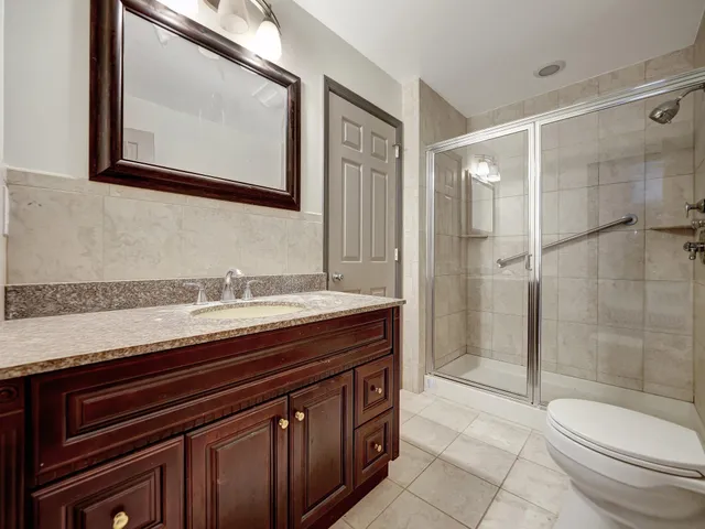 a bathroom with a sink a toilet and mirror
