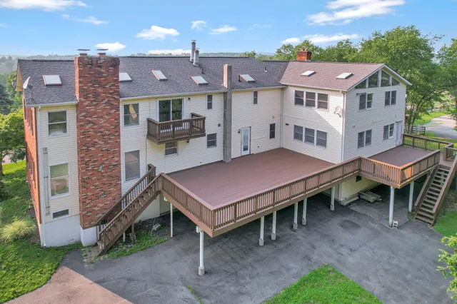 a backyard of a house with table and chairs