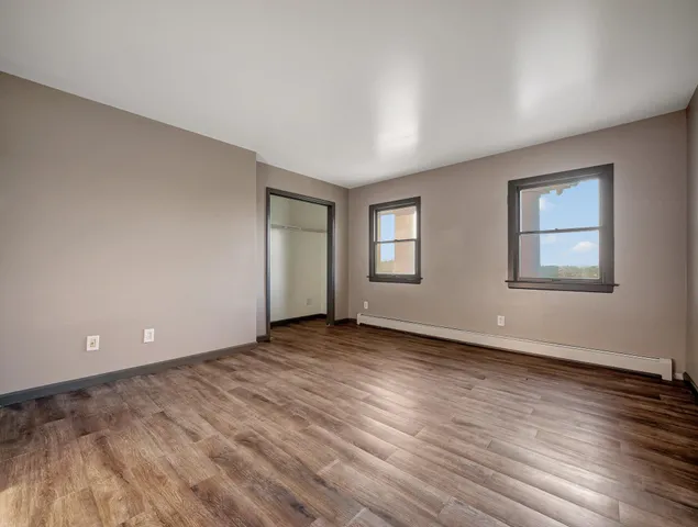 a bathroom with a granite countertop bathtub sink vanity mirror and toilet