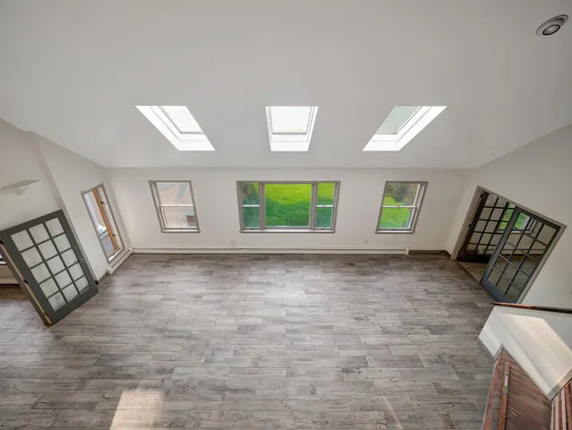a bathroom with a granite countertop sink a toilet and a mirror