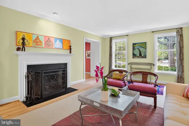 a living room with furniture a rug and a fireplace
