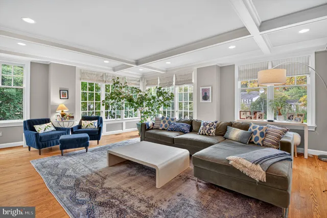 a living room with furniture large window and a fireplace