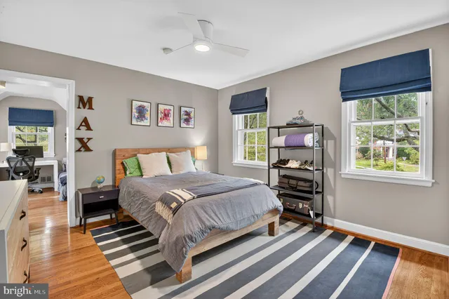 a bedroom with a bed a dresser and a window