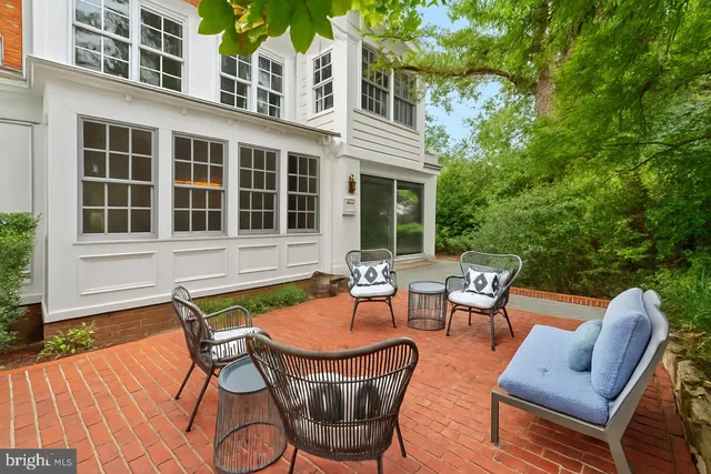a view of a patio with table and chairs and couches