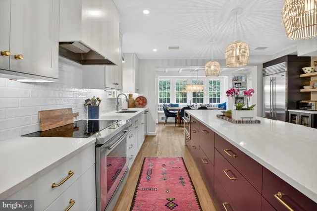 a kitchen with stainless steel appliances cabinets and wooden floor
