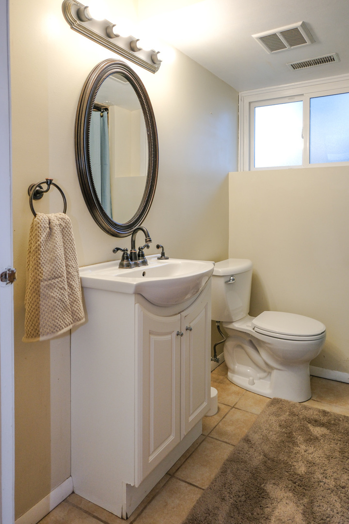 S586 East Street Winfield, IL 60190 - Photo 15 of 29 a bathroom with a sink a toilet and a mirror