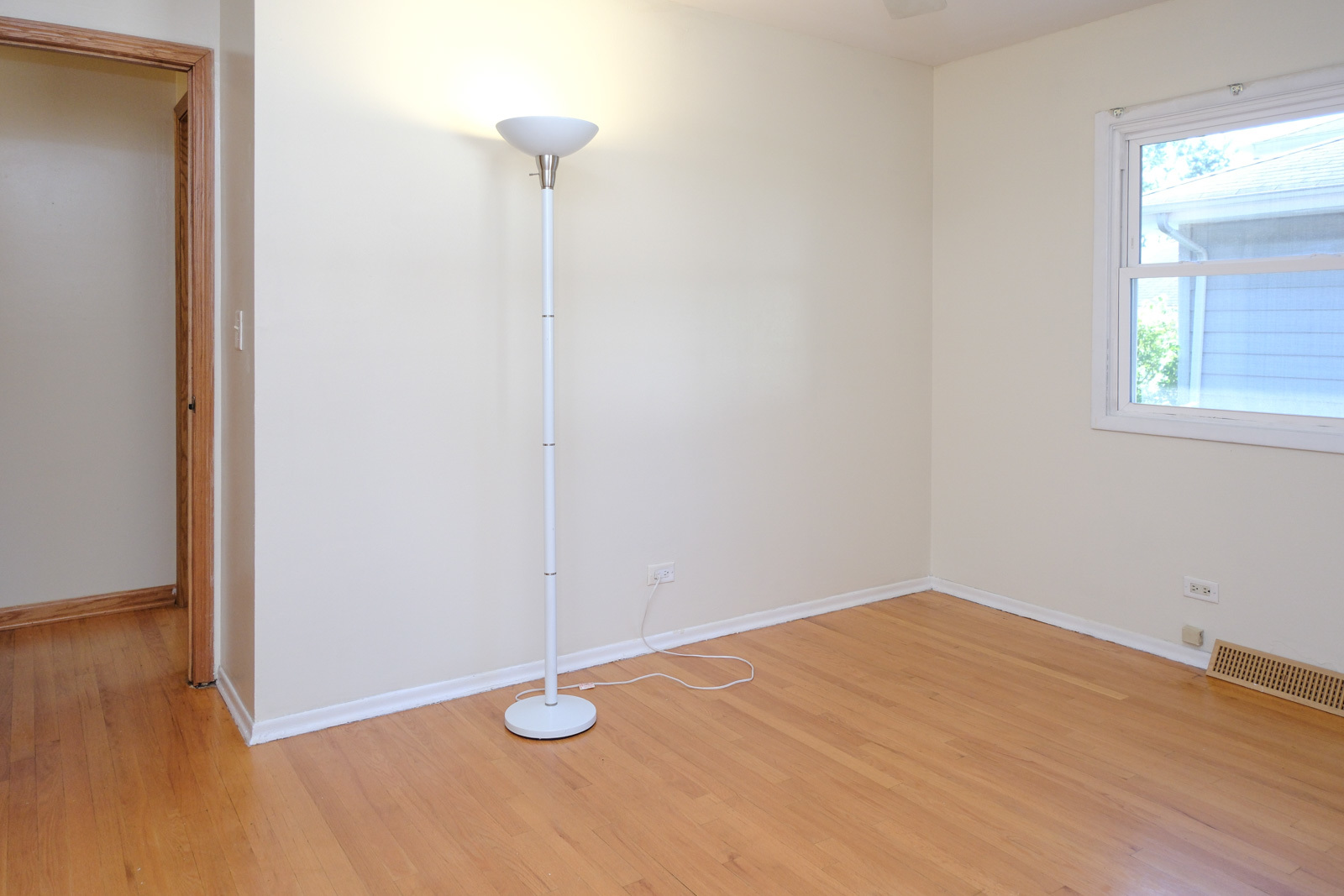 S586 East Street Winfield, IL 60190 - Photo 24 of 29 a view of an empty room with wooden floor and a window