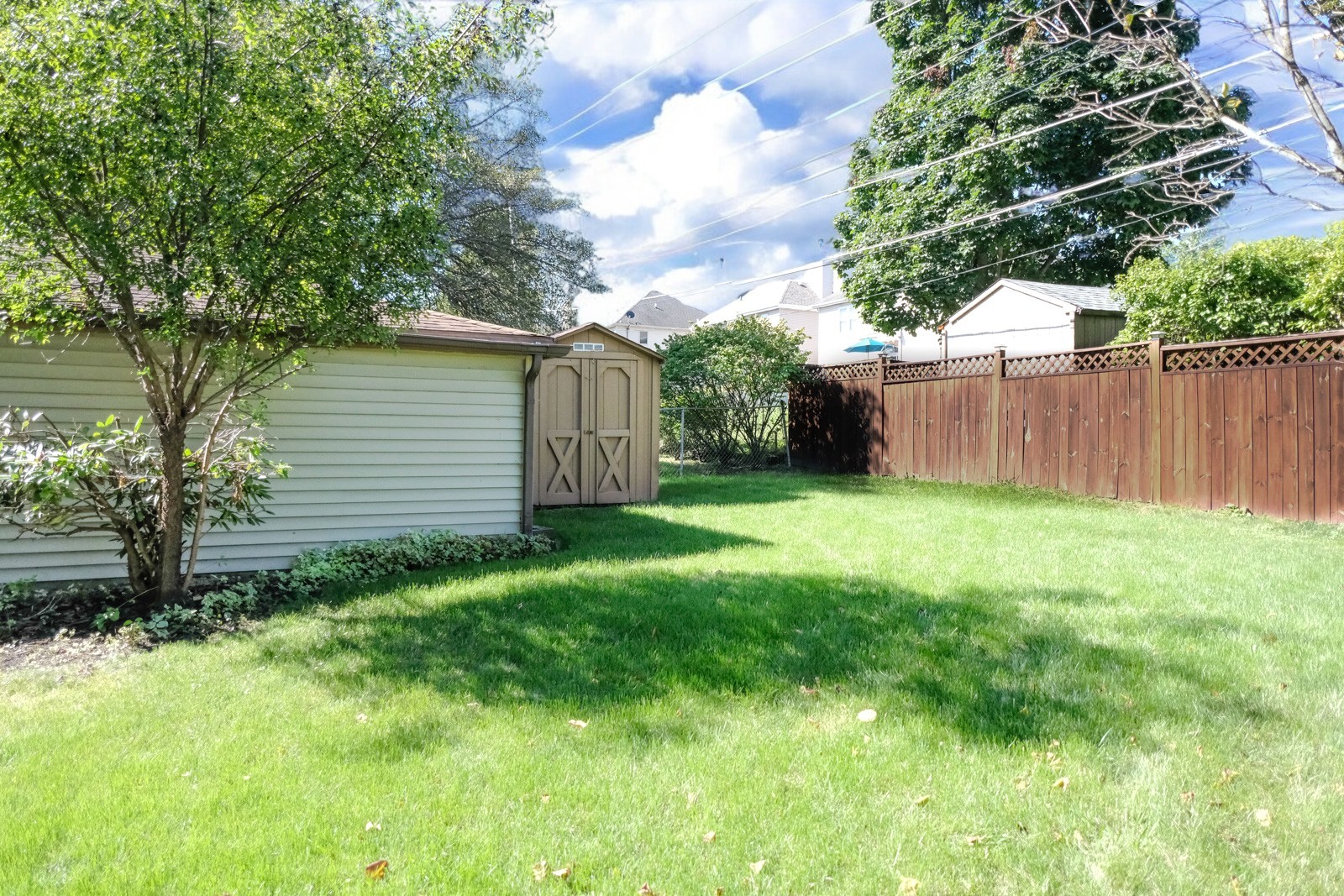S586 East Street Winfield, IL 60190 - Photo 29 of 29 a view of a backyard with potted plants and wooden fence