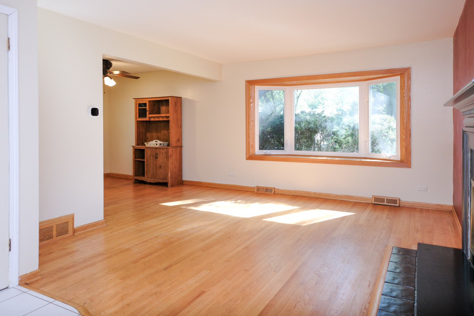 S586 East Street Winfield, IL 60190 - Photo 7 of 29 an empty room with wooden floor and windows