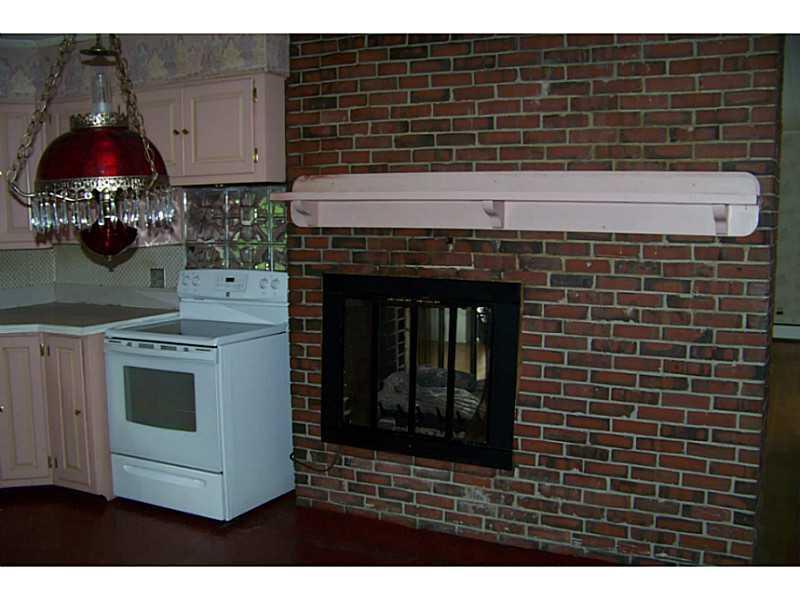 69 Mann Hill Road Holden, ME 04429 - Photo 9 of 28 Kitchen. View of the gas fireplace...