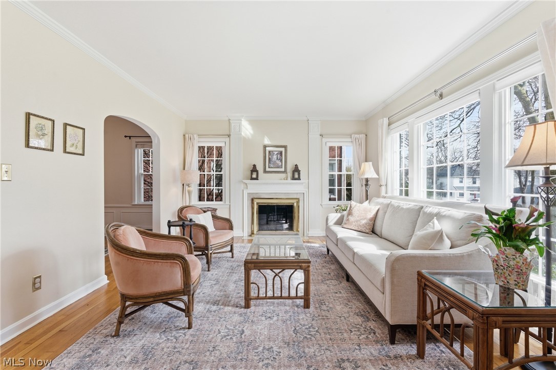 2552 Channing Road Cleveland, OH 44118 - Photo 2 of 33 Living room featuring gas fireplace, large picture window, crown molding and hardwood floors.