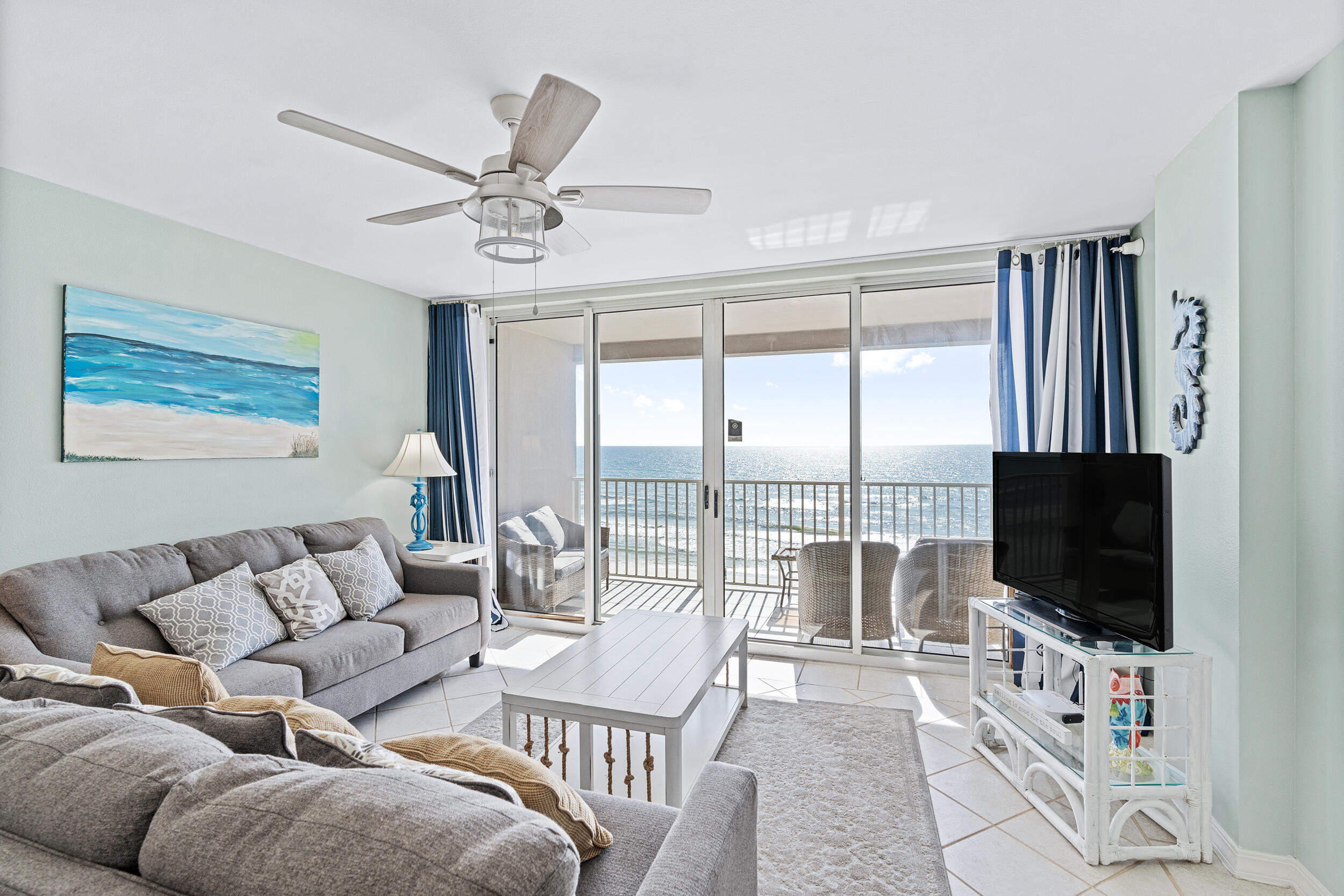520 Santa Rosa Boulevard, Unit 705 Fort Walton Beach, FL 32548 - Photo 11 of 36 a living room with furniture a flat screen tv and a large window