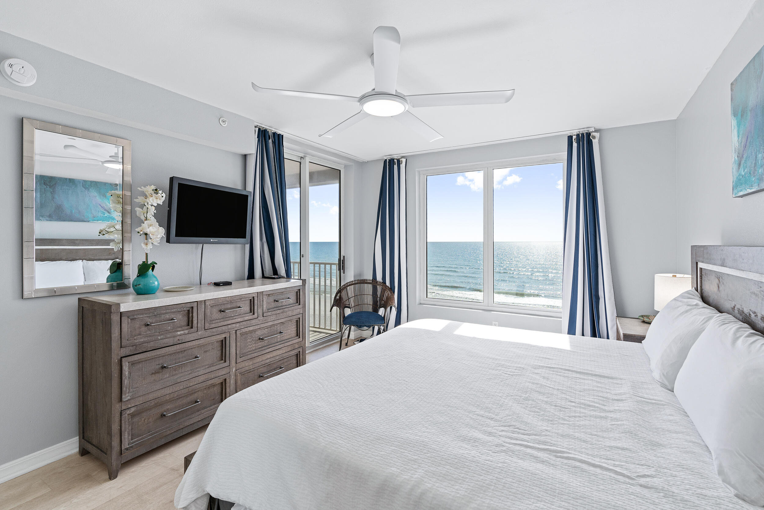 520 Santa Rosa Boulevard, Unit 705 Fort Walton Beach, FL 32548 - Photo 13 of 36 a bedroom with a large bed and a flat tv screen on dresser