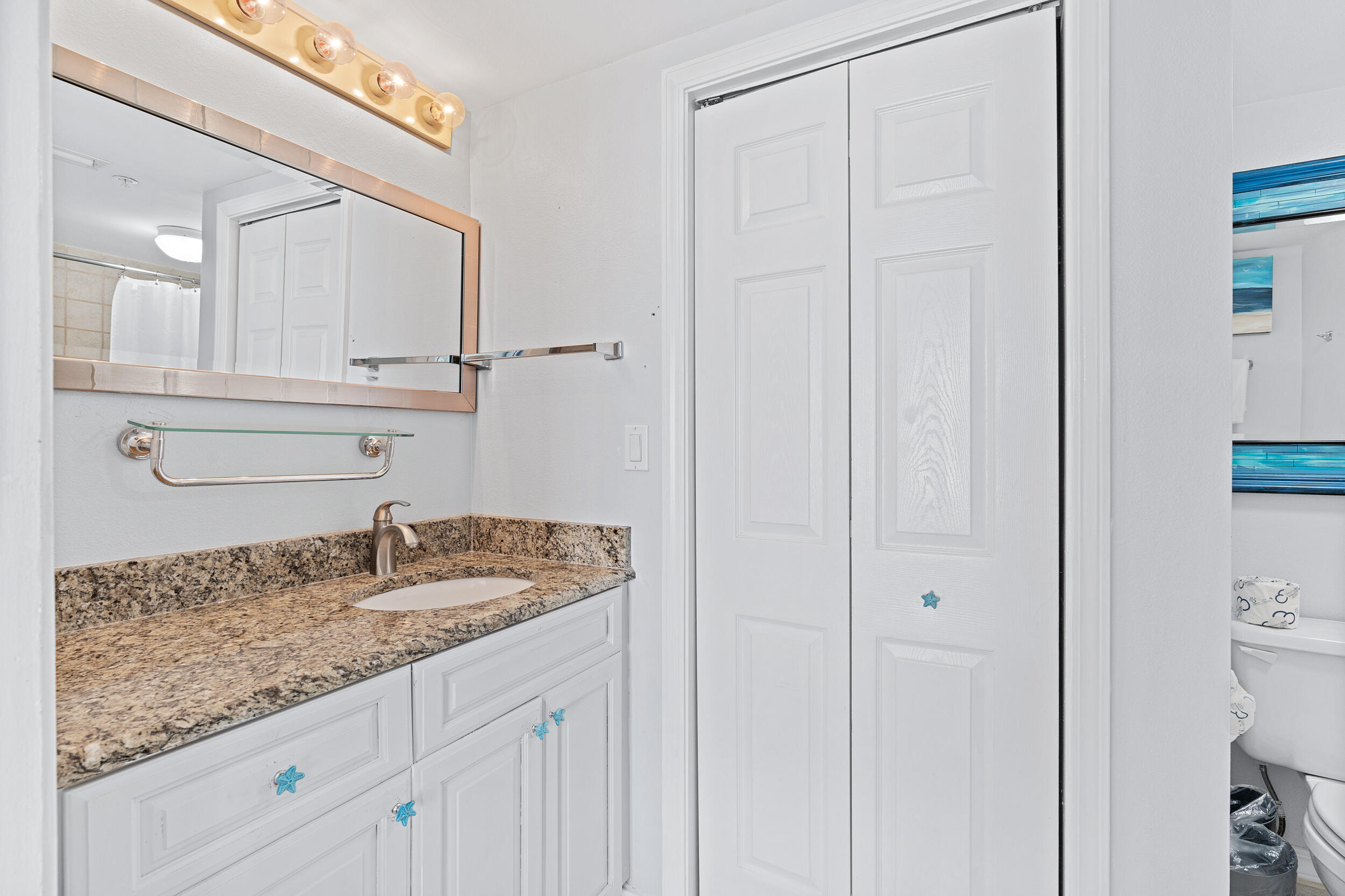 520 Santa Rosa Boulevard, Unit 705 Fort Walton Beach, FL 32548 - Photo 16 of 36 a bathroom with a granite countertop sink and white cabinets