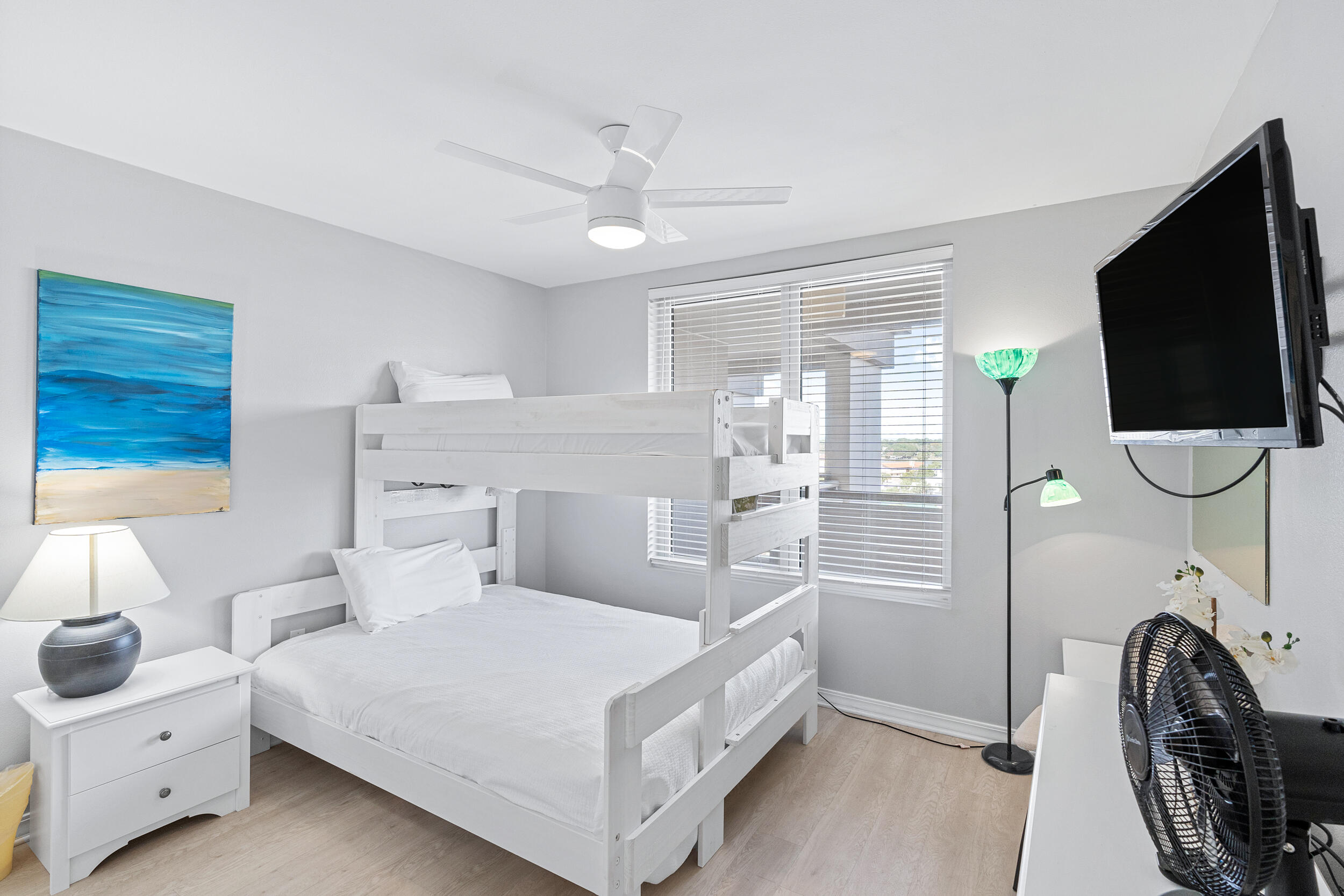 520 Santa Rosa Boulevard, Unit 705 Fort Walton Beach, FL 32548 - Photo 18 of 36 a bed room with a bed a flat tv screen and a chandelier