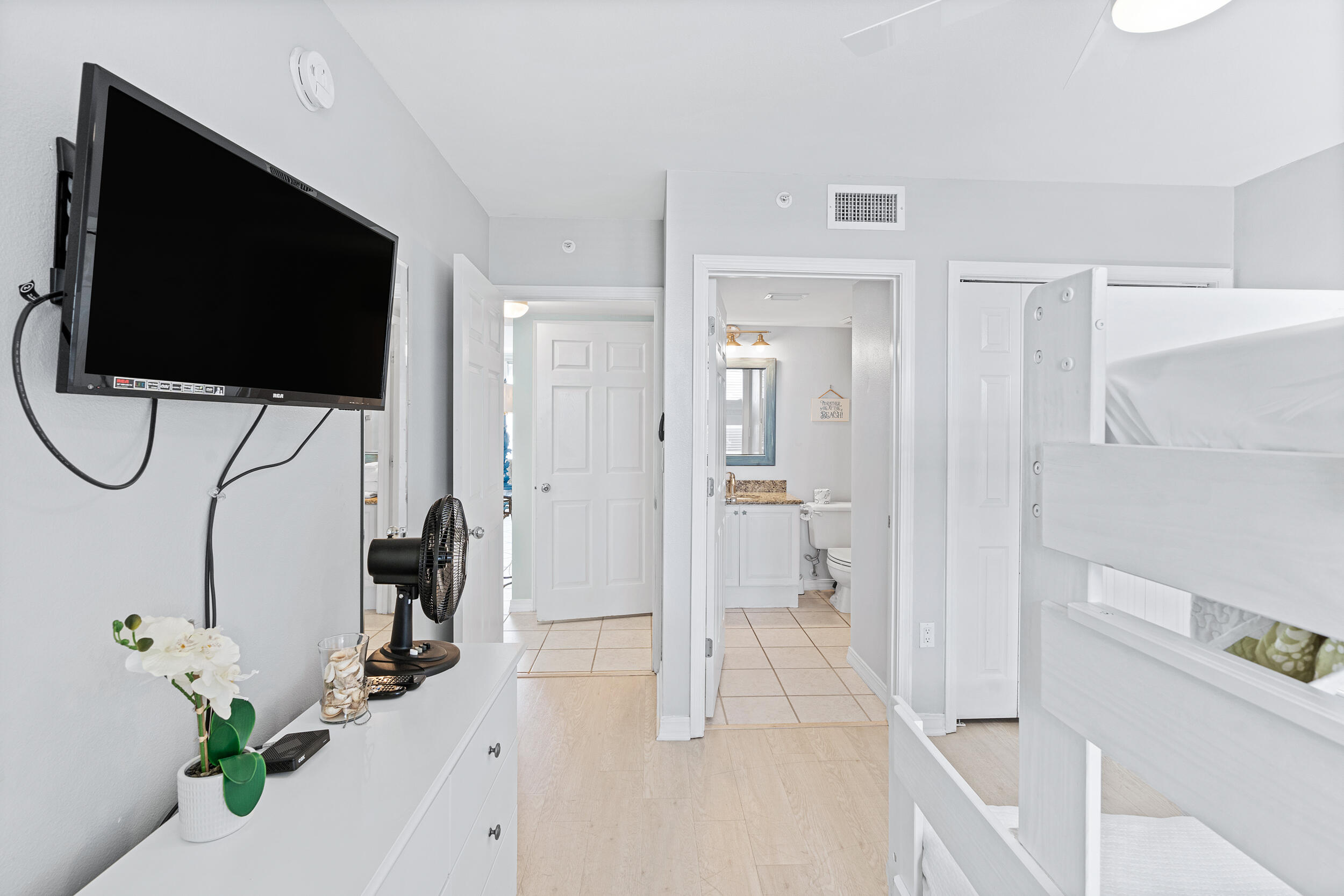 520 Santa Rosa Boulevard, Unit 705 Fort Walton Beach, FL 32548 - Photo 19 of 36 a living room with a flat screen tv and a glass door