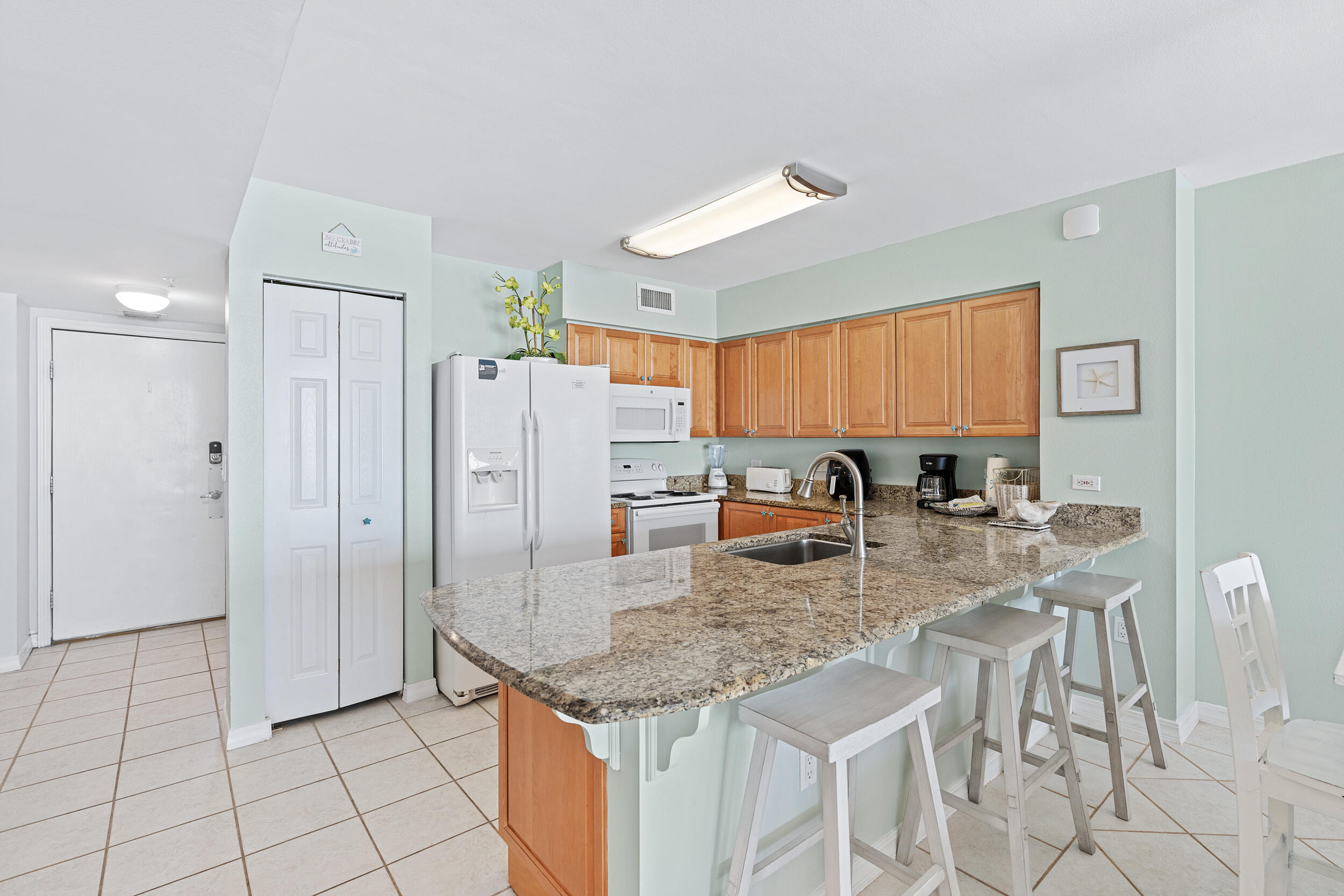 520 Santa Rosa Boulevard, Unit 705 Fort Walton Beach, FL 32548 - Photo 7 of 36 a kitchen with stainless steel appliances granite countertop a refrigerator and a stove top oven