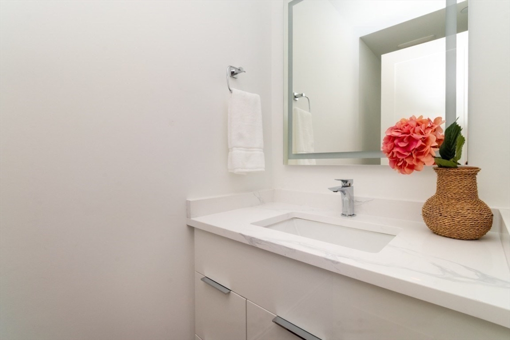 15 Tanglewood Road, Unit A Boston, MA 02126 - Photo 7 of 28 a bathroom with a sink and a mirror