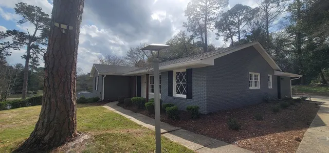 a backyard of a house with yard barbeque oven and outdoor seating