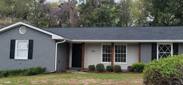 a front view of a house with garden