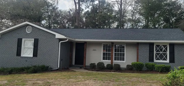 a front view of a house with garden