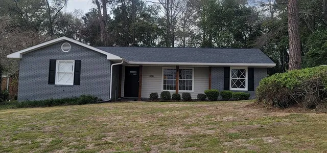 a front view of a house with a garden