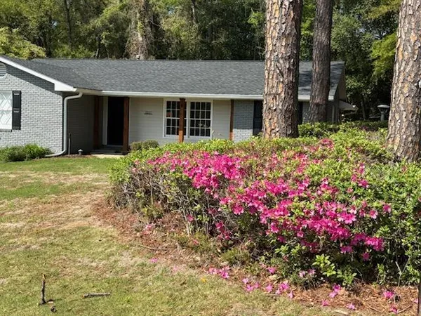 a front view of house with yard and flowers