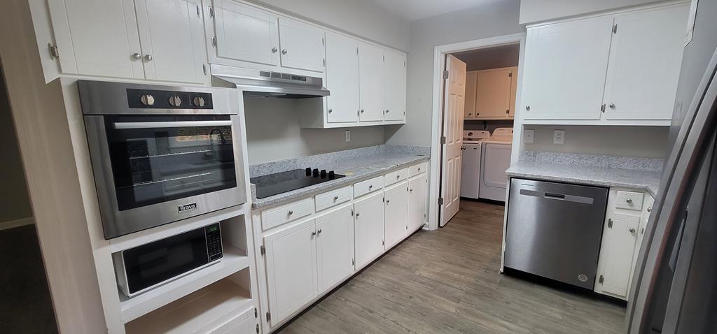 3327 College Avenue Columbus, GA 31907 - Photo 3 of 29 a kitchen with stainless steel appliances white cabinets and a stove
