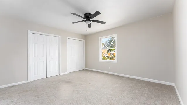 a view of room with window and ceiling fan