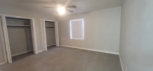an empty room with closet area