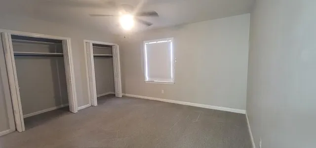 an empty room with closet area