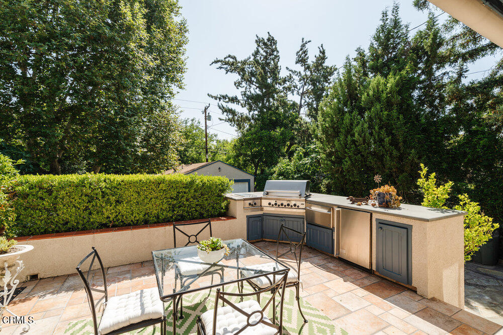 2484 Page Drive Altadena, CA 91001 - Photo 16 of 27 a view of a patio with a table and chairs under an umbrella