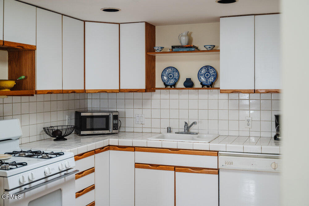 2484 Page Drive Altadena, CA 91001 - Photo 23 of 27 a kitchen with stainless steel appliances a cabinets and a stove top oven