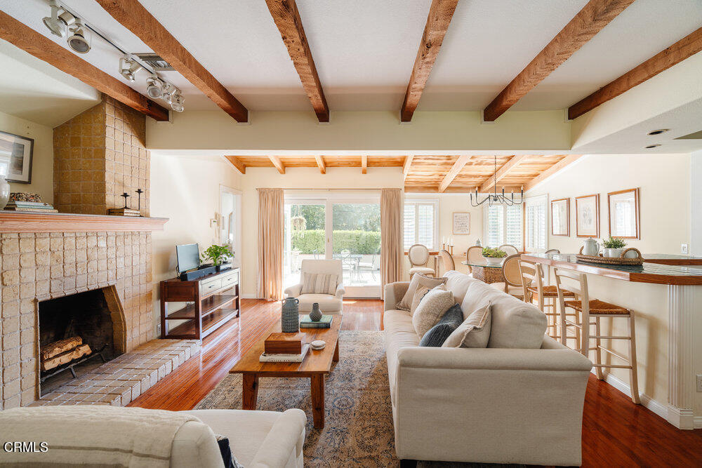 2484 Page Drive Altadena, CA 91001 - Photo 3 of 27 a living room with furniture a fireplace and a floor to ceiling window