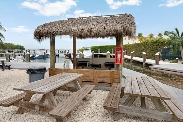 a swimming pool with a lawn chairs under an umbrella