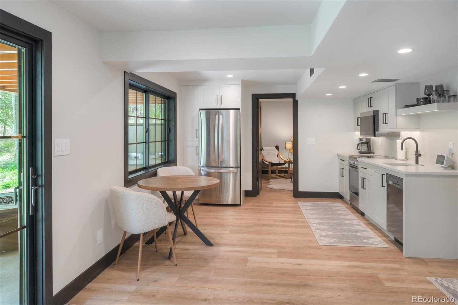 306 Golden Eagle Road Silverthorne, CO 80498 - Photo 29 of 43 a view of a kitchen with kitchen island dining table and wooden floor