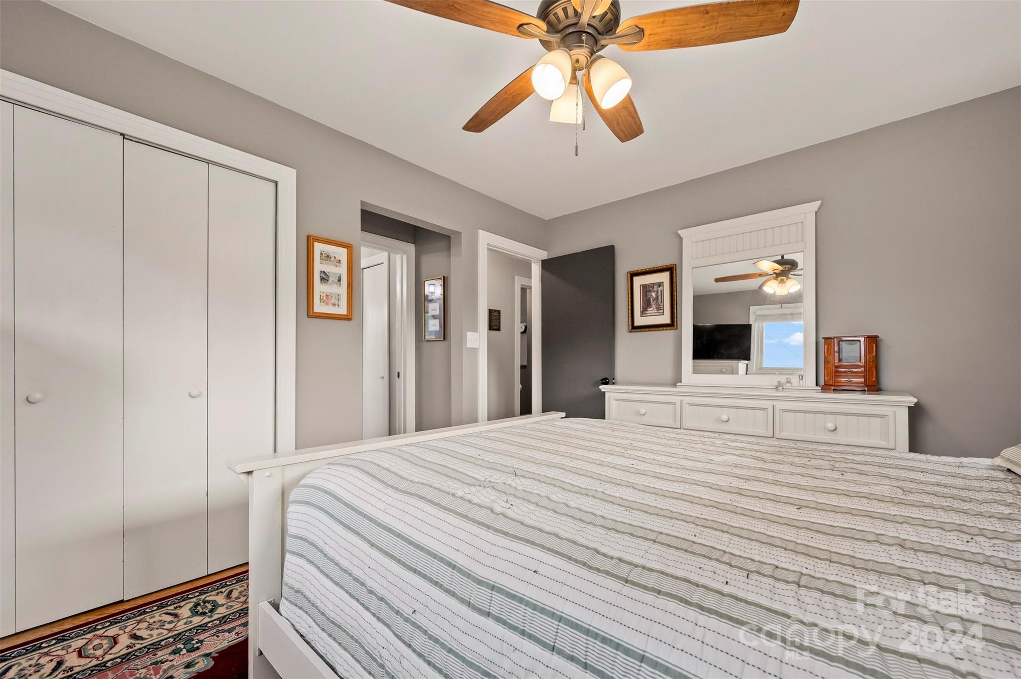 690-684 Chimney Rock Road Rutherfordton, NC 28139 - Photo 23 of 39 a bedroom with a large bed and a chandelier