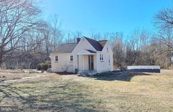 a view of a house with a yard covered in snow