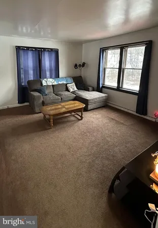 a living room with furniture and windows