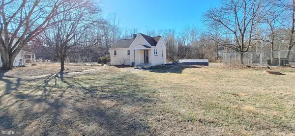 a view of a house with a yard covered in snow