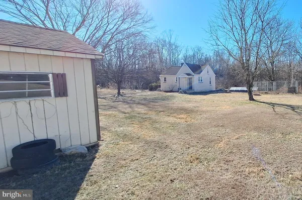 a backyard of house with large trees